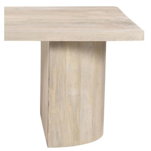Beige wooden table with a thick square top and curved base.
