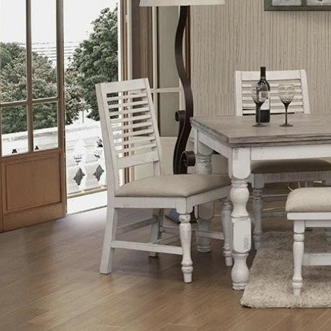 White wooden chair with slatted back and cushioned seat.