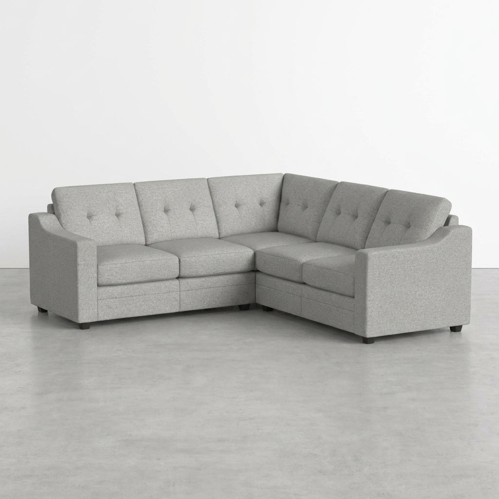 Gray corner sofa on a minimalist floor.
