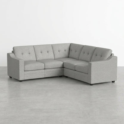 Gray corner sofa on a minimalist floor.