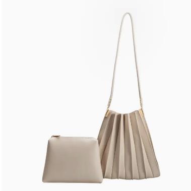 Beige pleated handbag and pouch on a white background.
