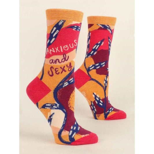 Colorful socks with "Anxious and Sexy" text and leafy design.