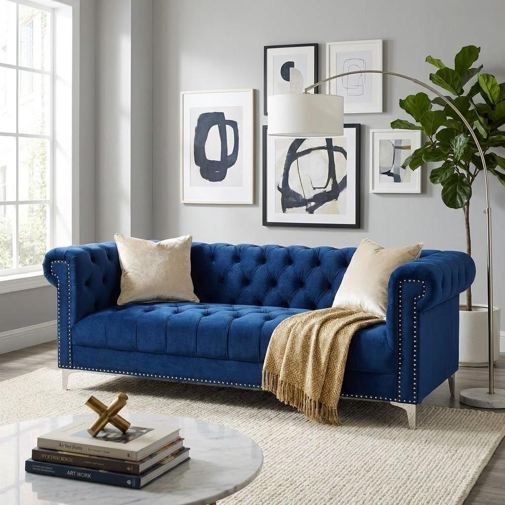 Blue velvet Chesterfield sofa, side view.