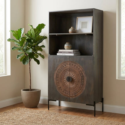 Tall cabinet with shelves, intricate circular design on lower doors.