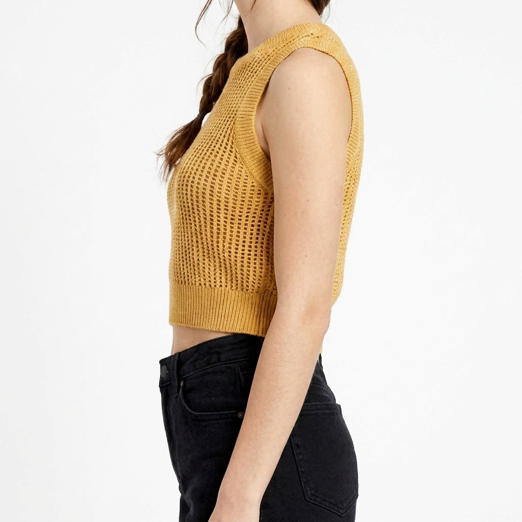 Person in yellow sleeveless top, side view, braided hair.