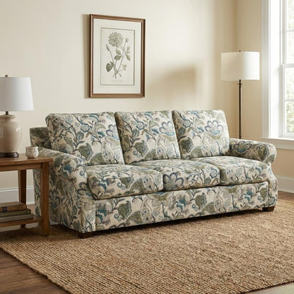 Floral sofa in cozy living room with lamp, artwork, and window.