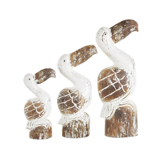 Three rustic wooden pelican sculptures in varying sizes.