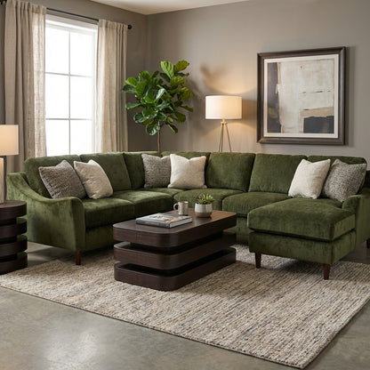 Cozy living room with green sofa, art, and indoor plant.