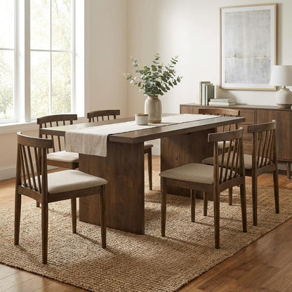 Modern dining room with a wooden table, six chairs, and decorative plants.
