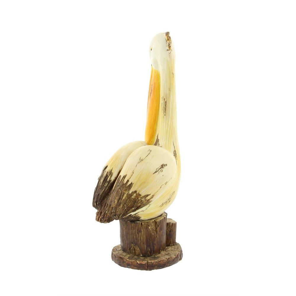 Carved wooden pelican on a tree stump base.