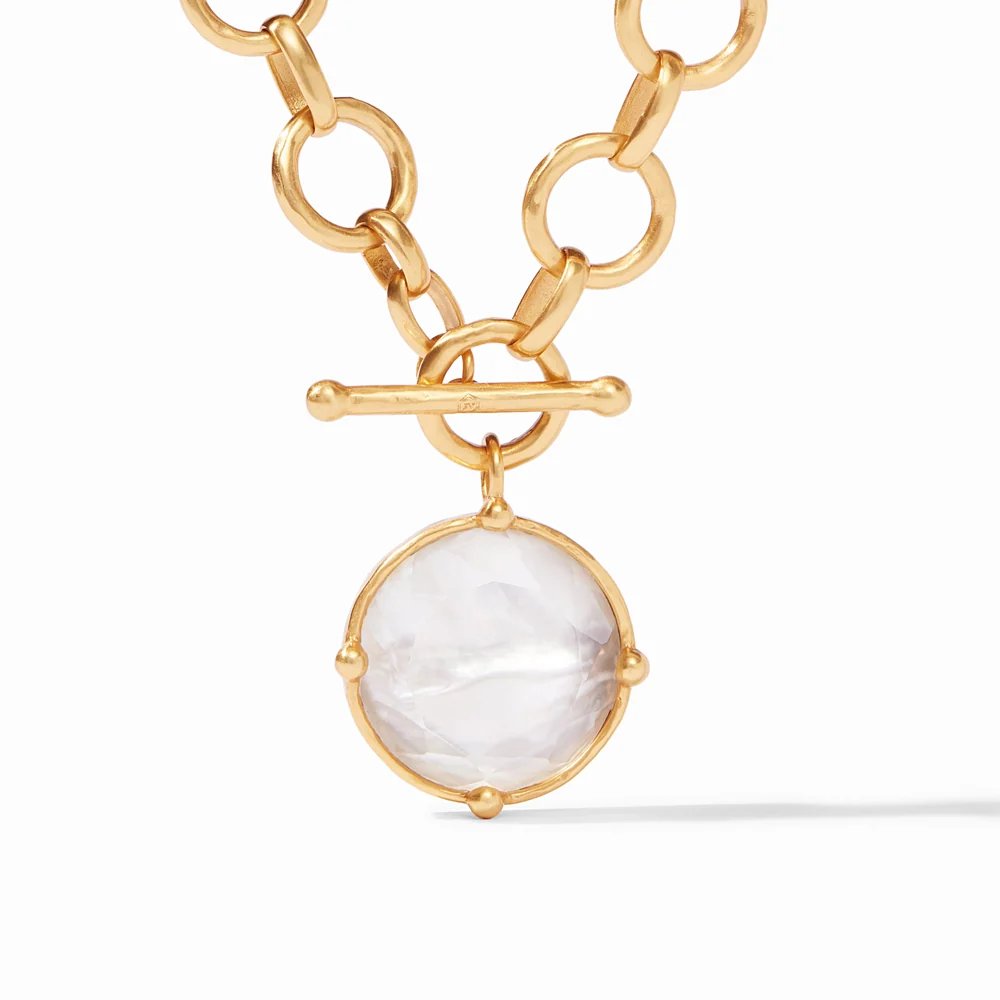 Gold chain necklace with round gemstone pendant.