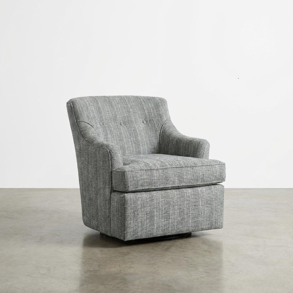 Gray upholstered armchair on a polished concrete floor.