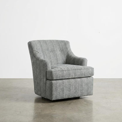 Gray upholstered armchair on a polished concrete floor.