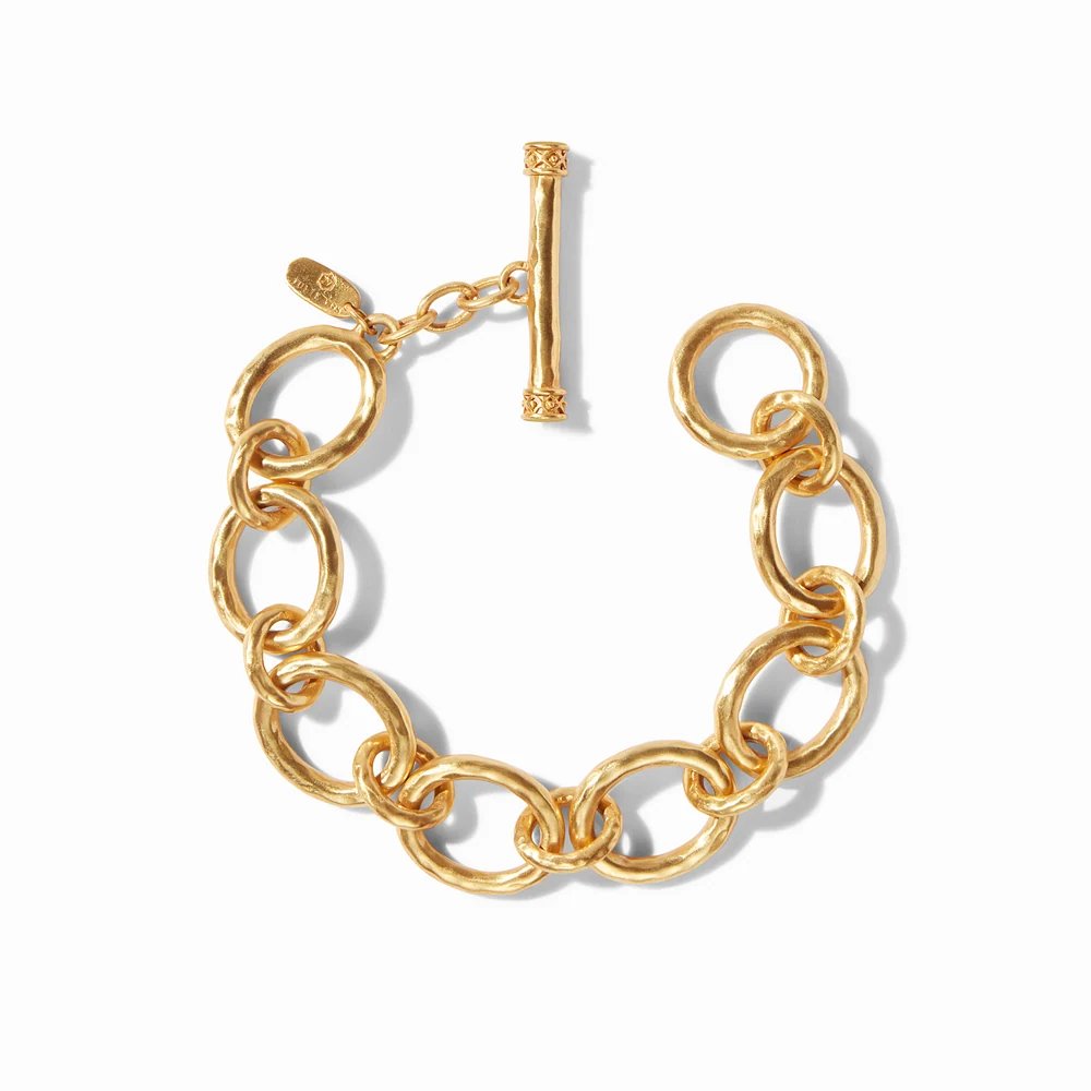 A chunky gold chain bracelet with a decorative toggle clasp, displayed on a white background.