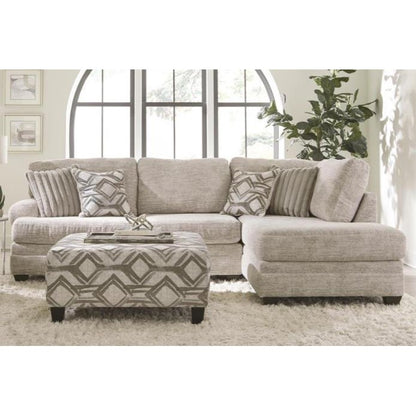 Cozy beige sectional sofa with cushions in a bright, stylish room.