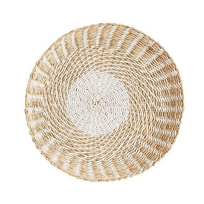 A round woven straw basket with a spiral pattern.