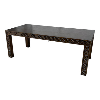 Wooden table with geometric carved edges.