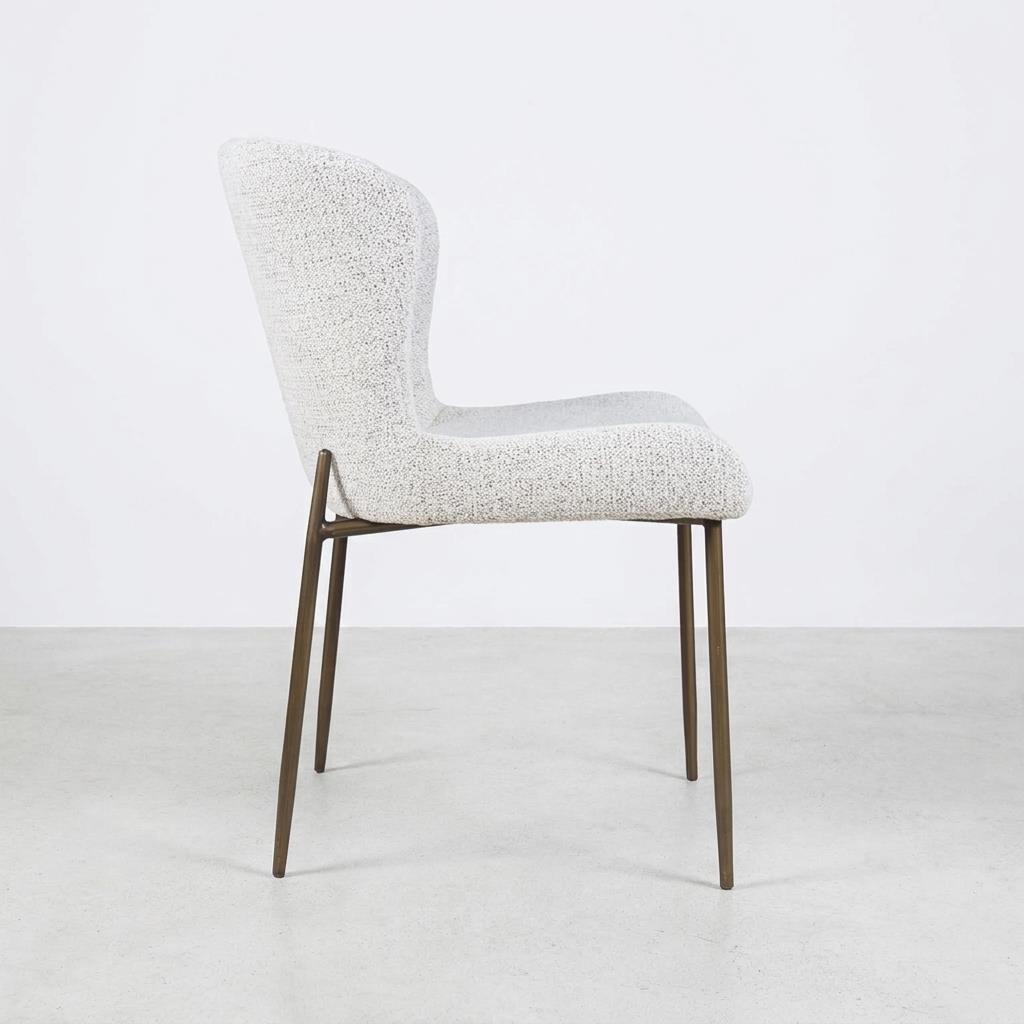 Modern chair with a textured seat and slender metal legs, side view.