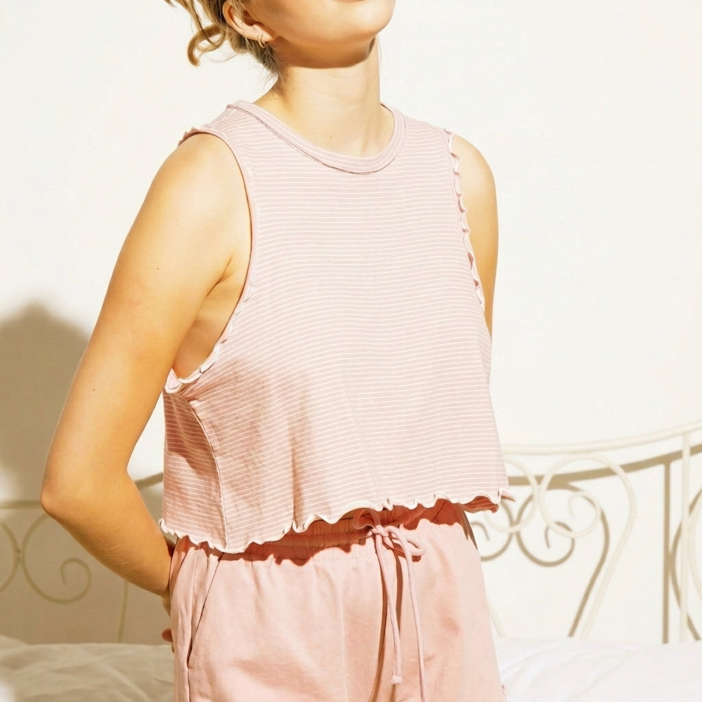 Person in pink loungewear standing against a white background.