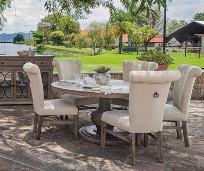 Outdoor dining set with a garden view by the water.