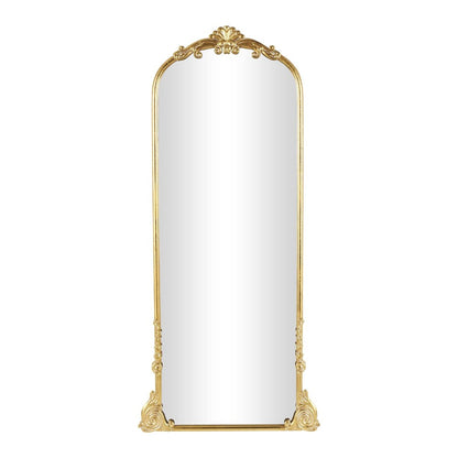 Elegant gold-framed floor mirror with ornate details.