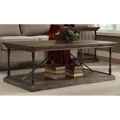 Rustic coffee table with books and a fruit bowl on top.