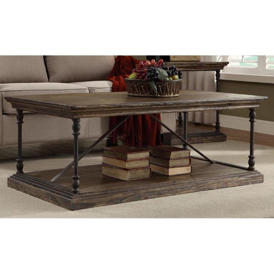 Rustic coffee table with books and a fruit bowl on top.
