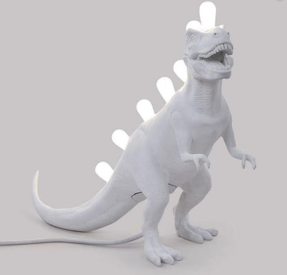 White dinosaur lamp with glowing bulb spikes.