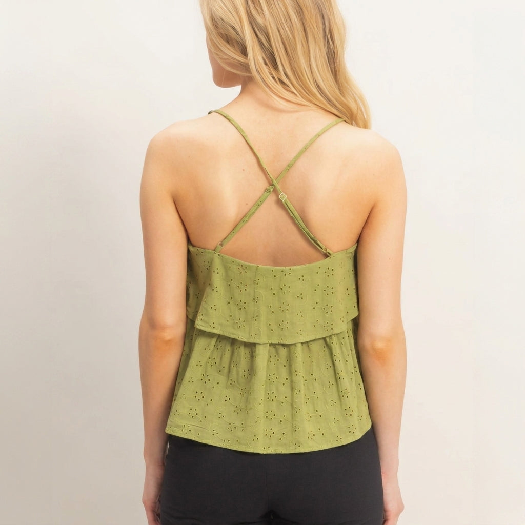 Woman in green strappy top with ruffled back.