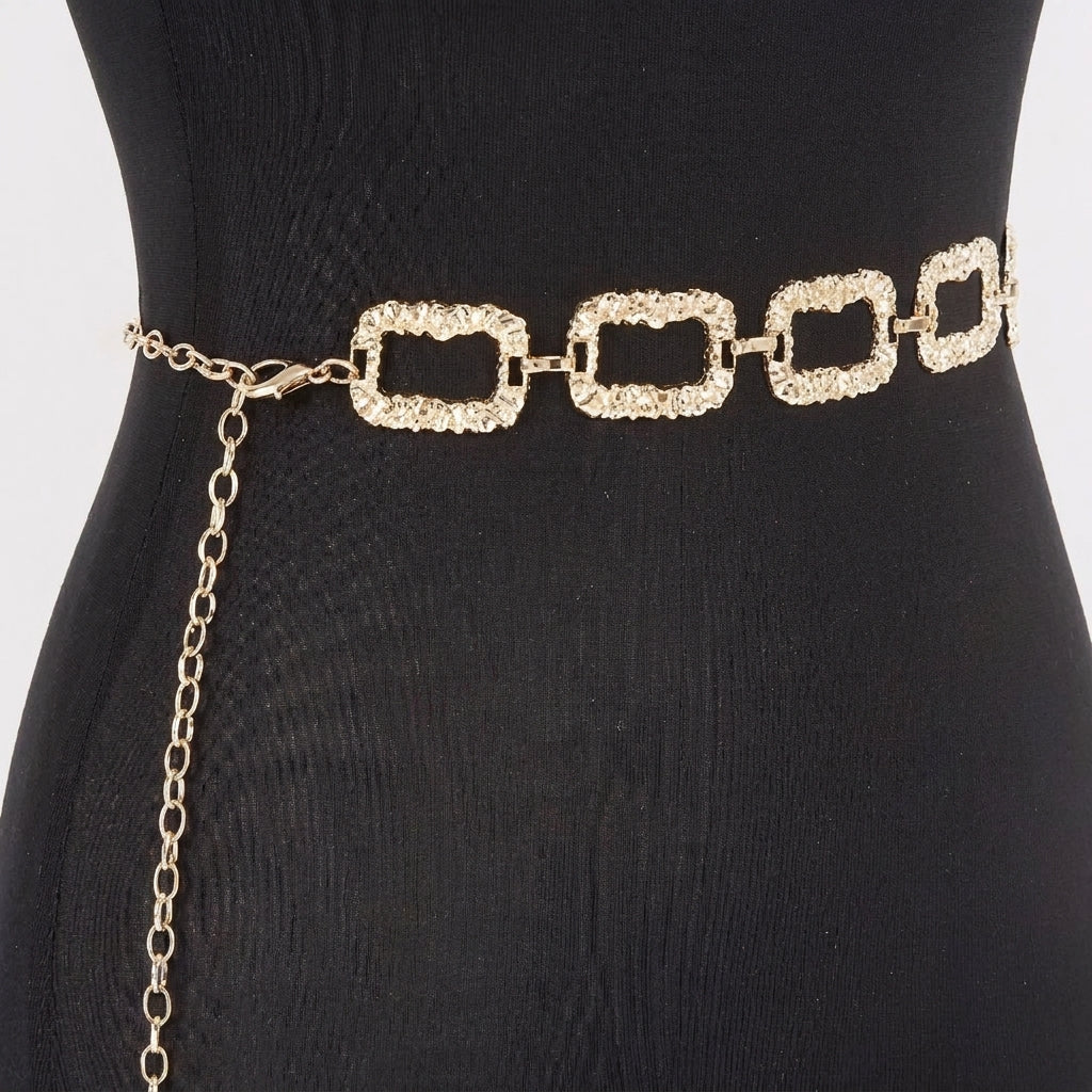 Gold chain belt on a black mannequin.
