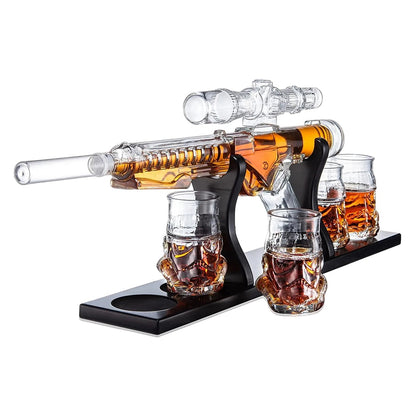 Glass gun decanter with whiskey and skull-shaped shot glasses.