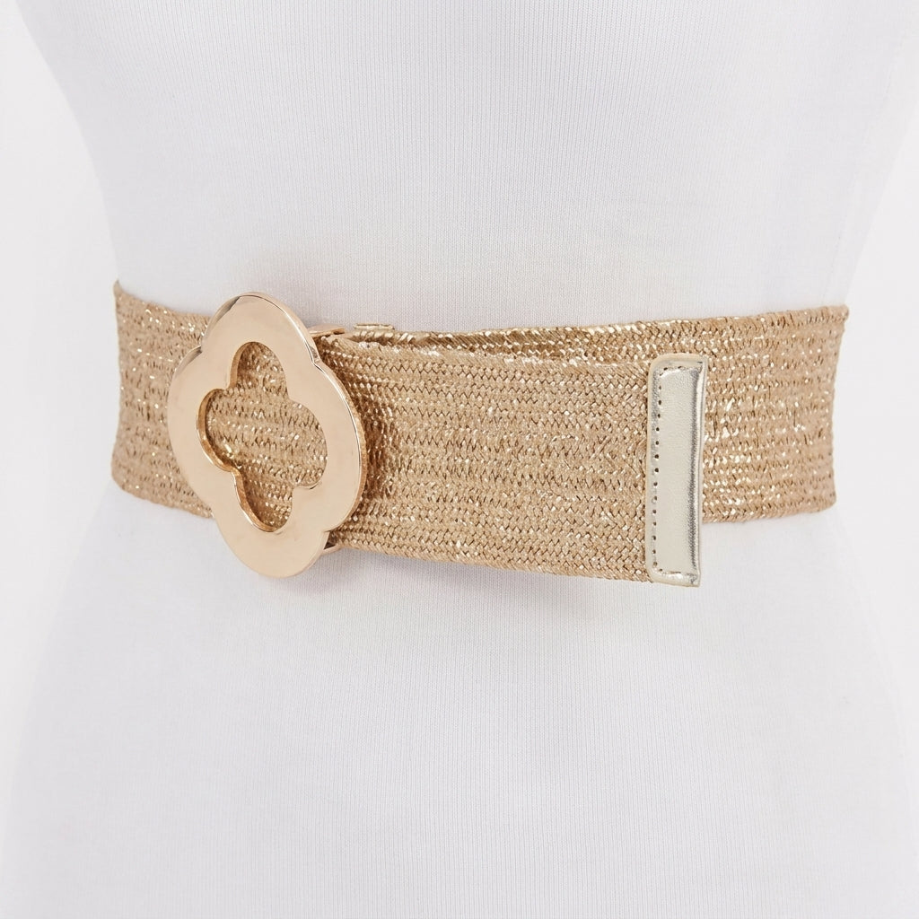 Gold woven belt with decorative floral buckle on display mannequin.
