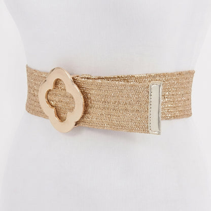 Gold woven belt with decorative floral buckle on display mannequin.