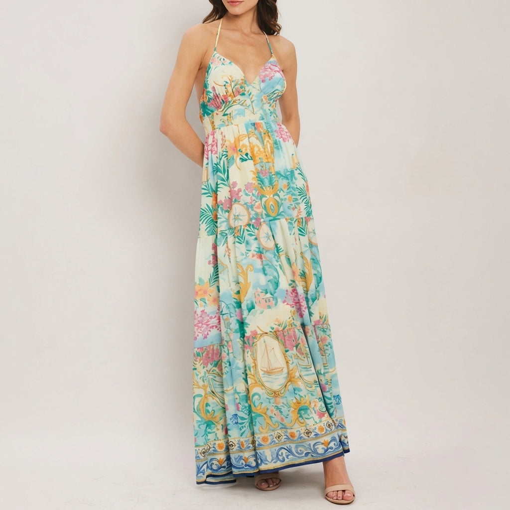 Woman in a colorful floral maxi dress standing against a white background.