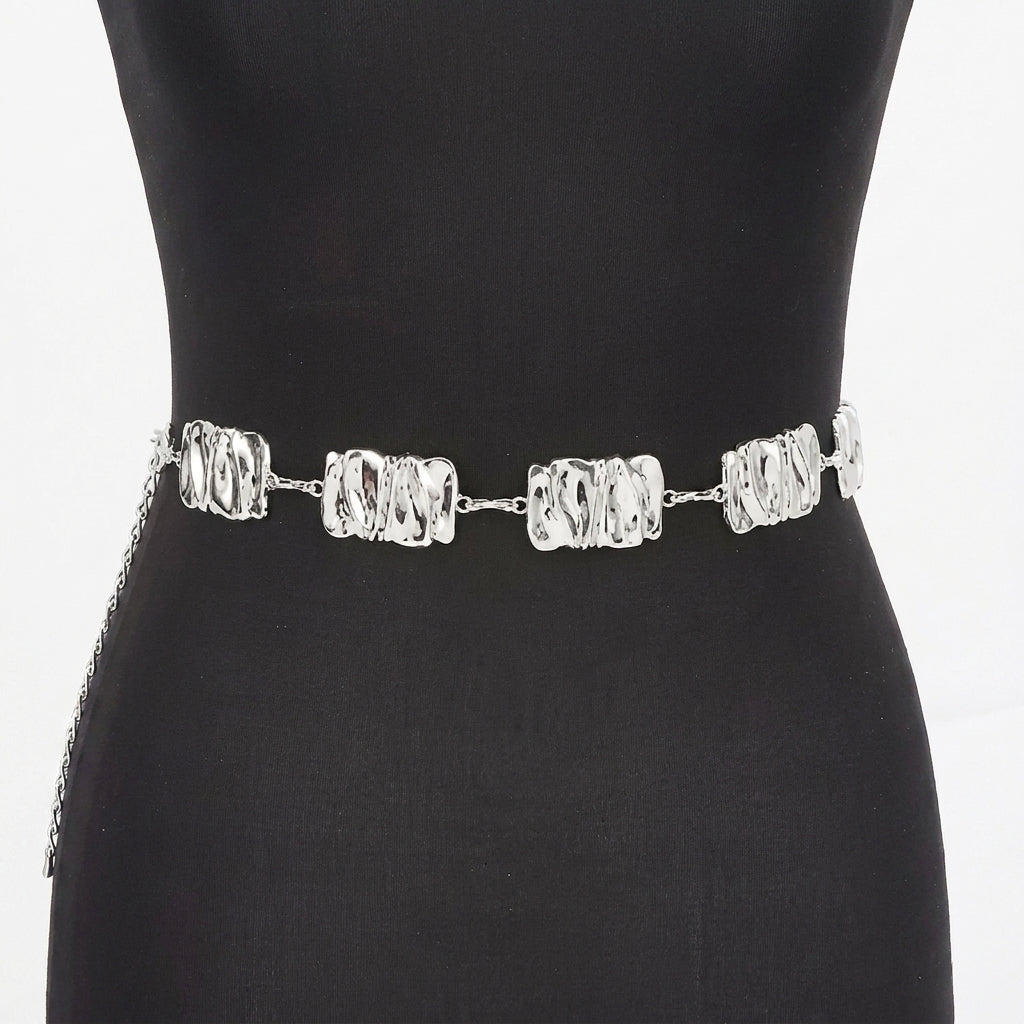 Silver chain belt with textured links on a black mannequin.