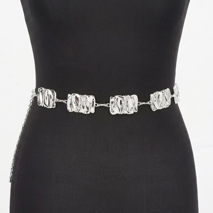 Silver chain belt with textured links on a black mannequin.