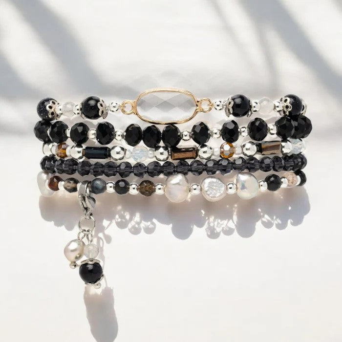 Elegant beaded bracelet set with pearls and black stones.