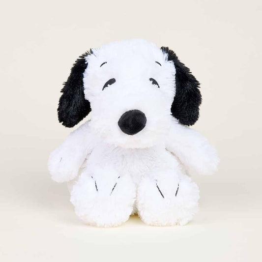 Fluffy plush toy dog with black ears on a soft background.