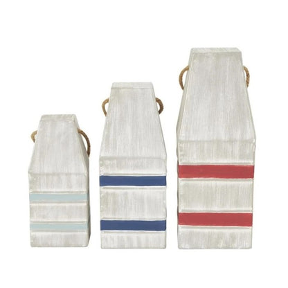 Three white buoys with colorful stripes and rope handles.