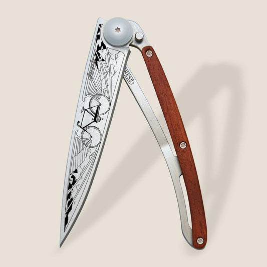 Folding knife with bicycle-themed blade and wooden handle.