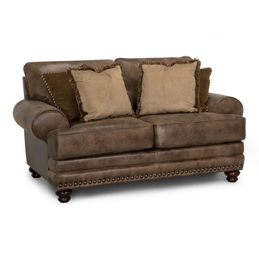 Brown leather sofa with four beige pillows.