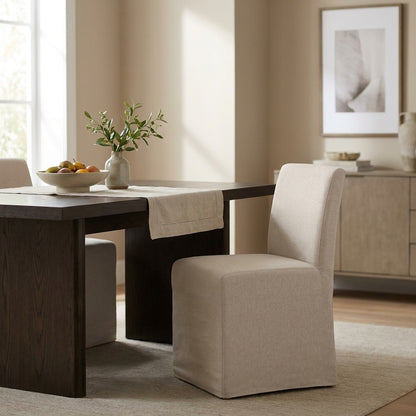 Simple beige upholstered chair with a boxy design.