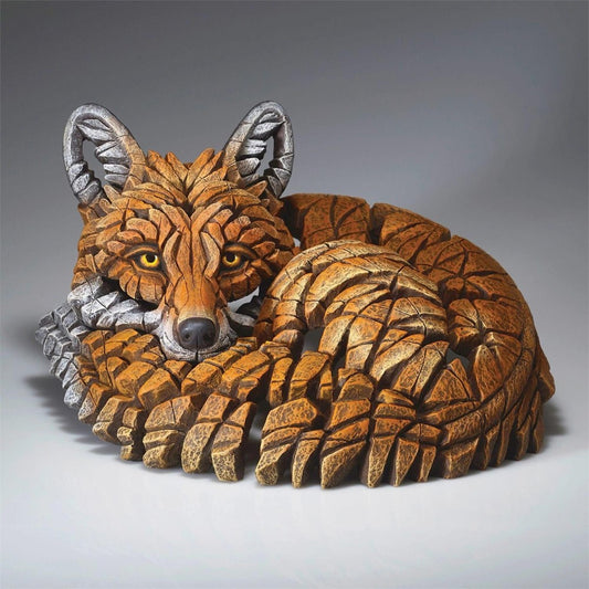 Intricately carved fox sculpture with geometric patterns.