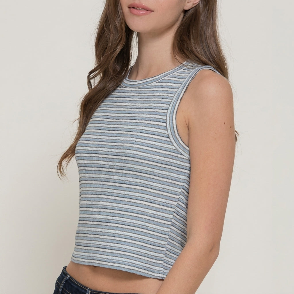 Woman in a striped sleeveless top with wavy hair.