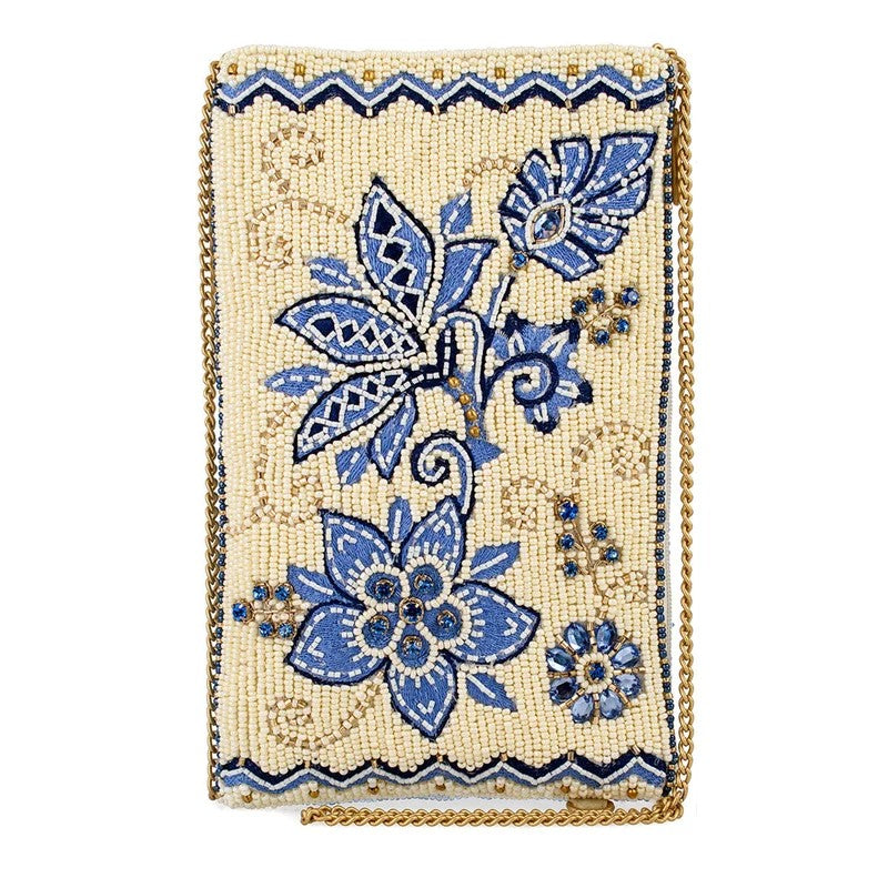 Beaded clutch with blue floral design and gold chain.