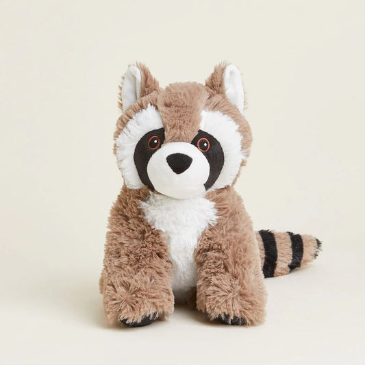 Cute plush raccoon toy with fluffy stripes on a beige background.