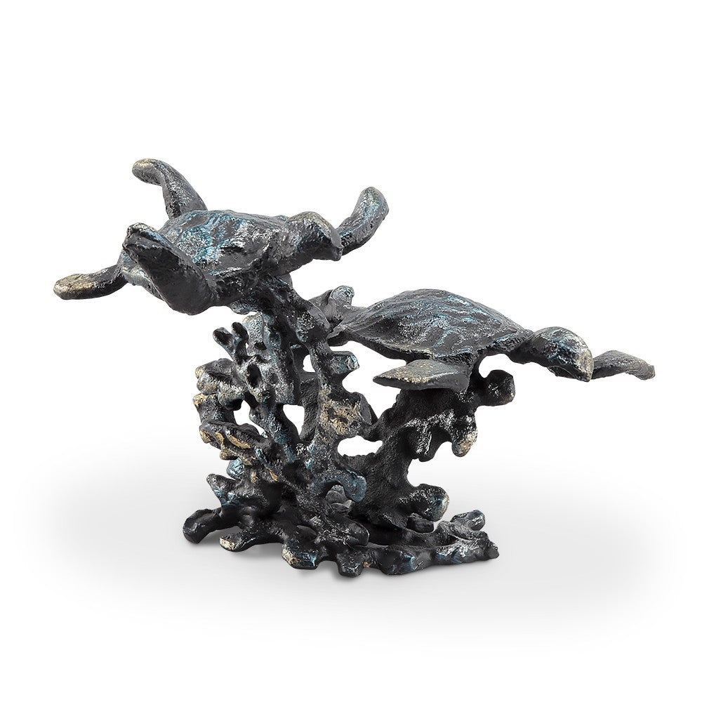 Two metal turtles swimming above coral in artistic sculpture.