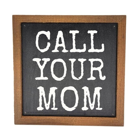 Sign saying "Call Your Mom" in a wooden frame.