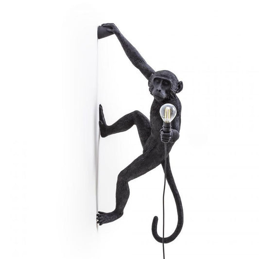 Monkey wall lamp holding a light bulb.