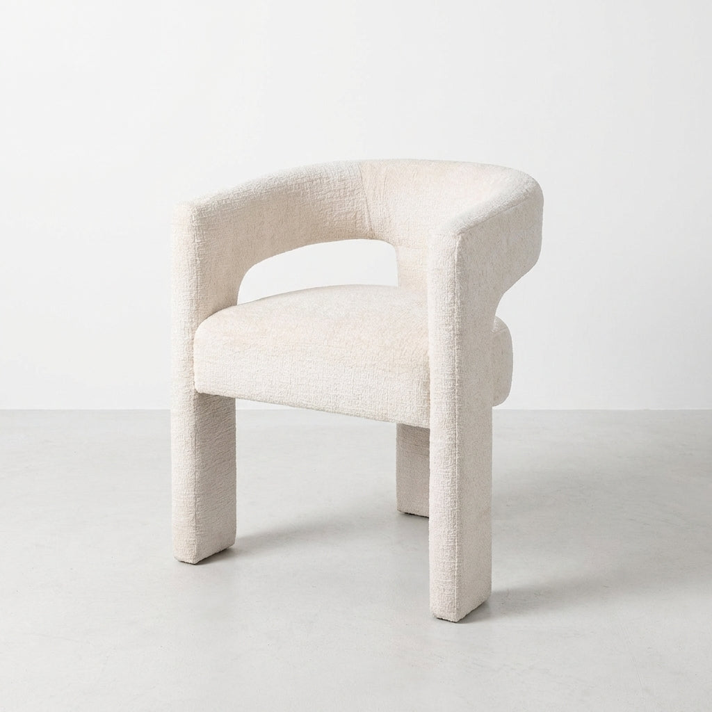 Modern white boucle chair with curved back.